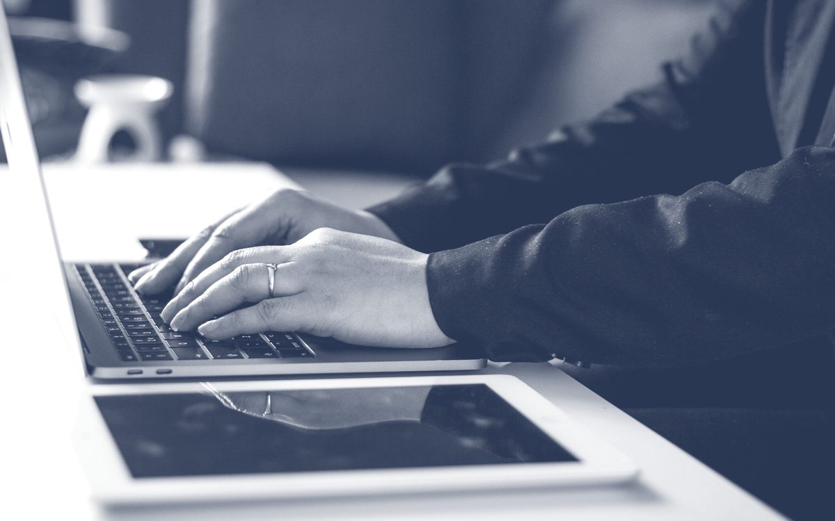 Hands working at a laptop